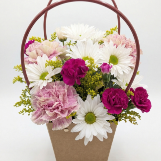 Fresh white daisy and carnation flower basket arrangement with purple and lavender blooms, delivered in Broward County by Irus Floral Design